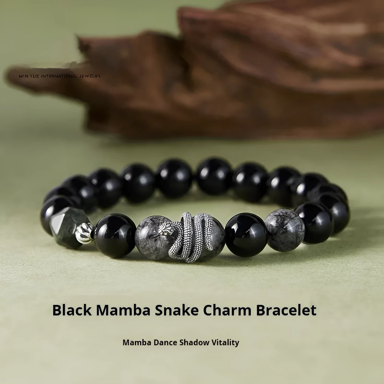 Men's retro snake bracelet in sterling silver with a large black obsidian stone on a dark background.