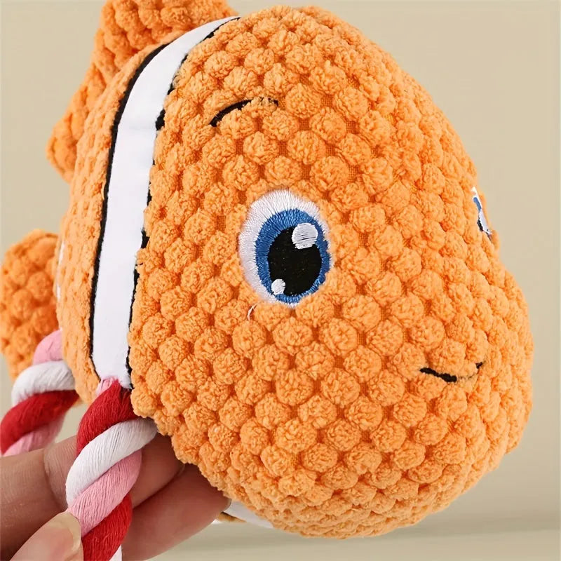 Grey, green, and orange turtle-shaped plush dog chew toy with knotted body.