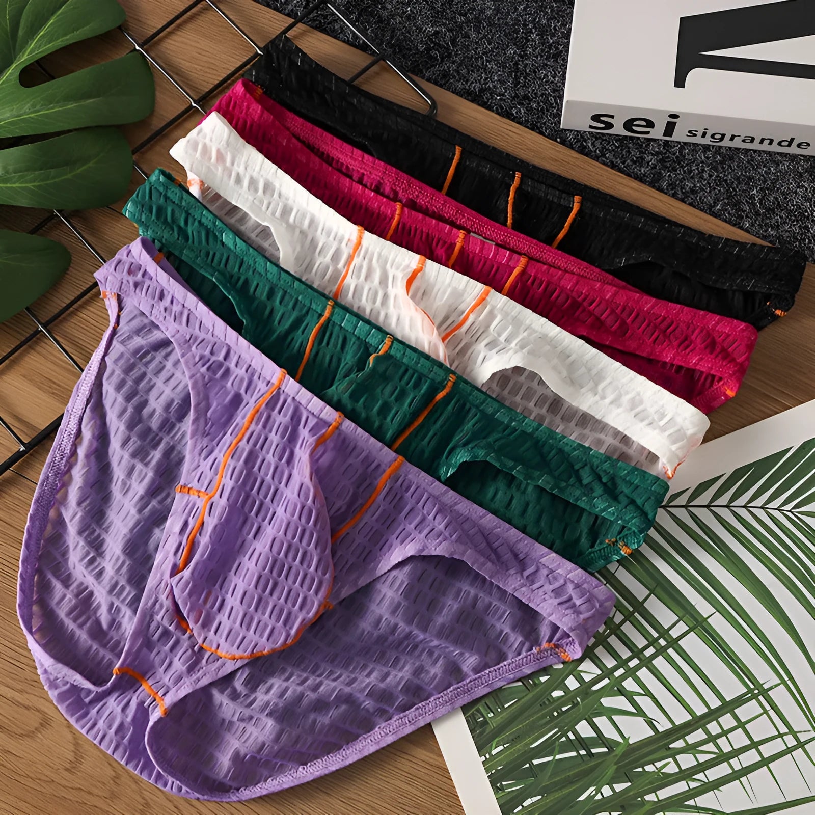 Men's solid colour low waist lace briefs for sports in white, black, green, rose red, and light purple.
