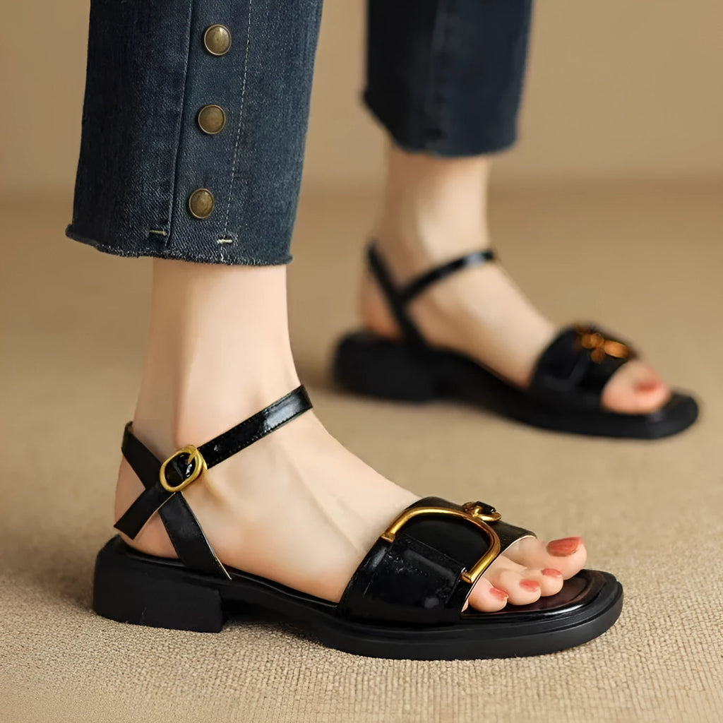 Women's black thick-soled casual sandals with a round toe and press-stud fastening.