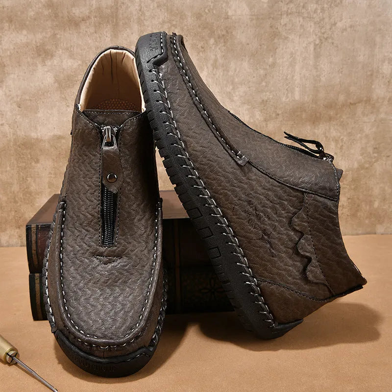 Men's slip-on loafers in black with round toe, low heel, and sewing thread details on PU upper