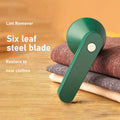White USB rechargeable electric lint remover shaver with removable lint collector container on a sweater.