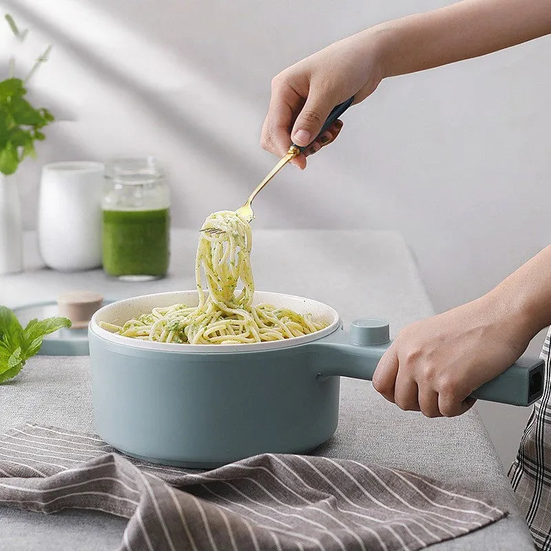 White or green portable electric hot pot cooker with multi-function controls on a countertop.