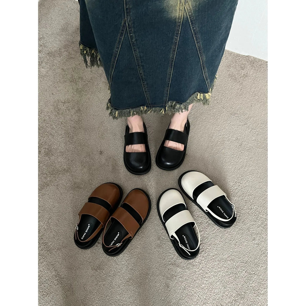Retro raised sole sandals with ankle-strap buckle in black microfiber