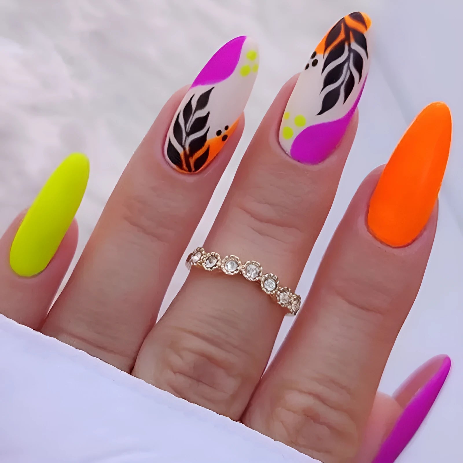 Wear Armour medium almond nail stickers with frosted tulip pattern in four designs: French leaves, leopard print, plating, and macaron