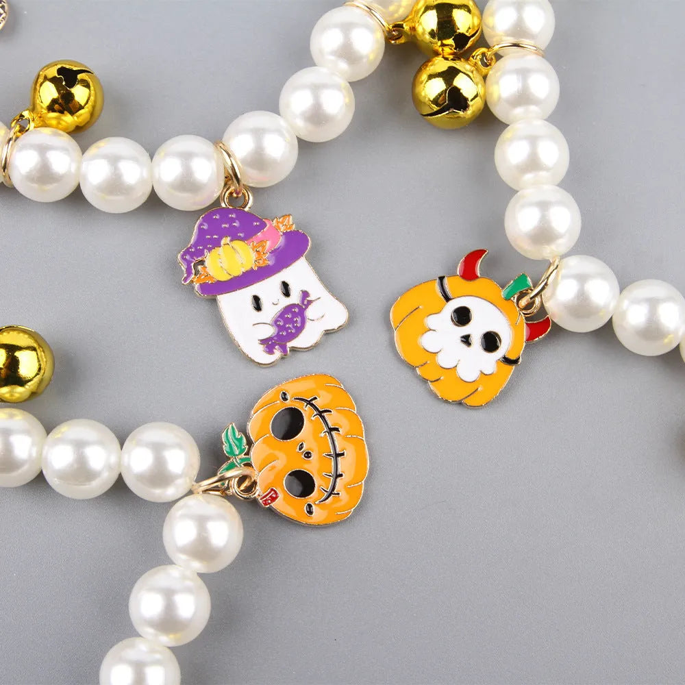 Halloween cat collar with simulated pearls and pumpkin designs in purple ghost, skull, and smiling motifs