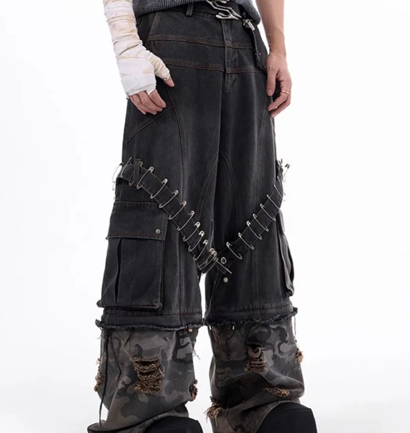 Men's grey jeans with camouflage pattern splicing and pin ribbon details on the legs.