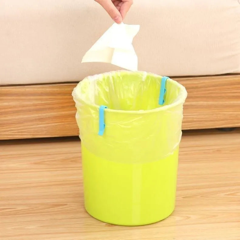 Black plastic non-slip clip for holding bin bags on the side of a trash can.
