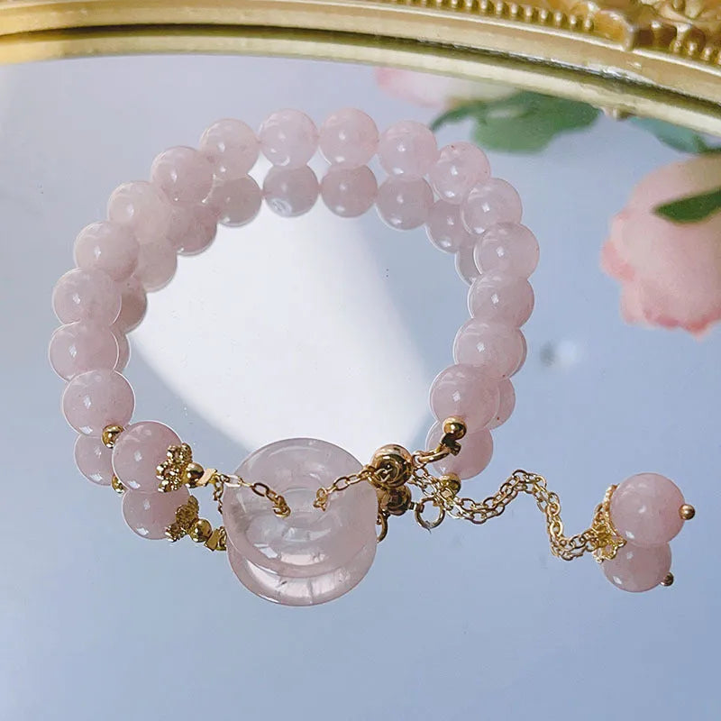 Women's pink crystal bracelet with peace buckle safety closure on wrist