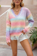 Pink knitted pullover sweater with a gradient rainbow pattern and loose, relaxed fit.