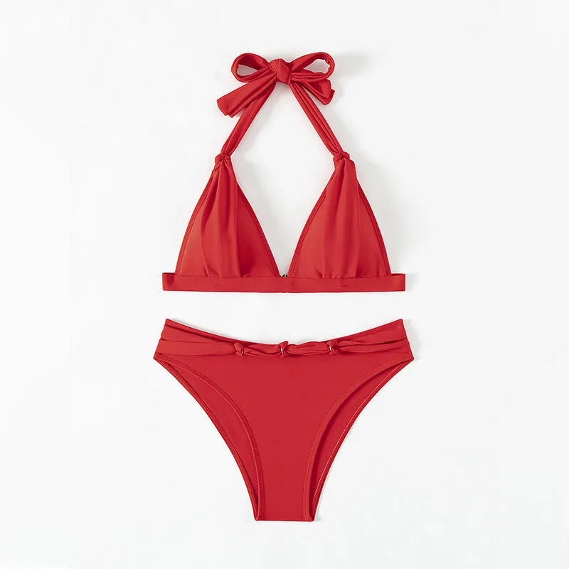 Red women's halterneck bikini with front lace-up detail and high-leg split shorts