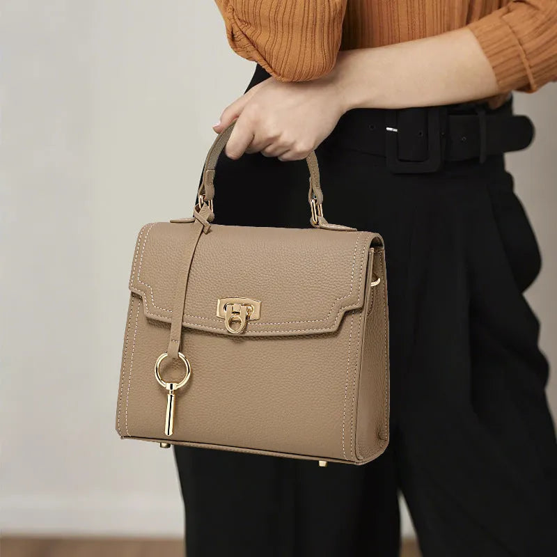 Elephant grey genuine leather crossbody handbag with litchi pattern, secure lock, and double shoulder straps