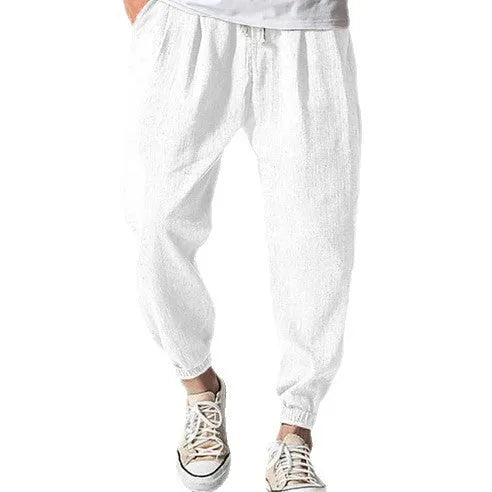 Man wearing loose light-coloured cotton trousers with a banded ankle cuff