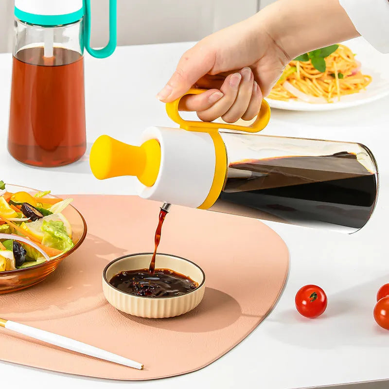 Yellow, green, and brown 550ml glass oil dispenser with silicone brush and stainless steel nozzle.