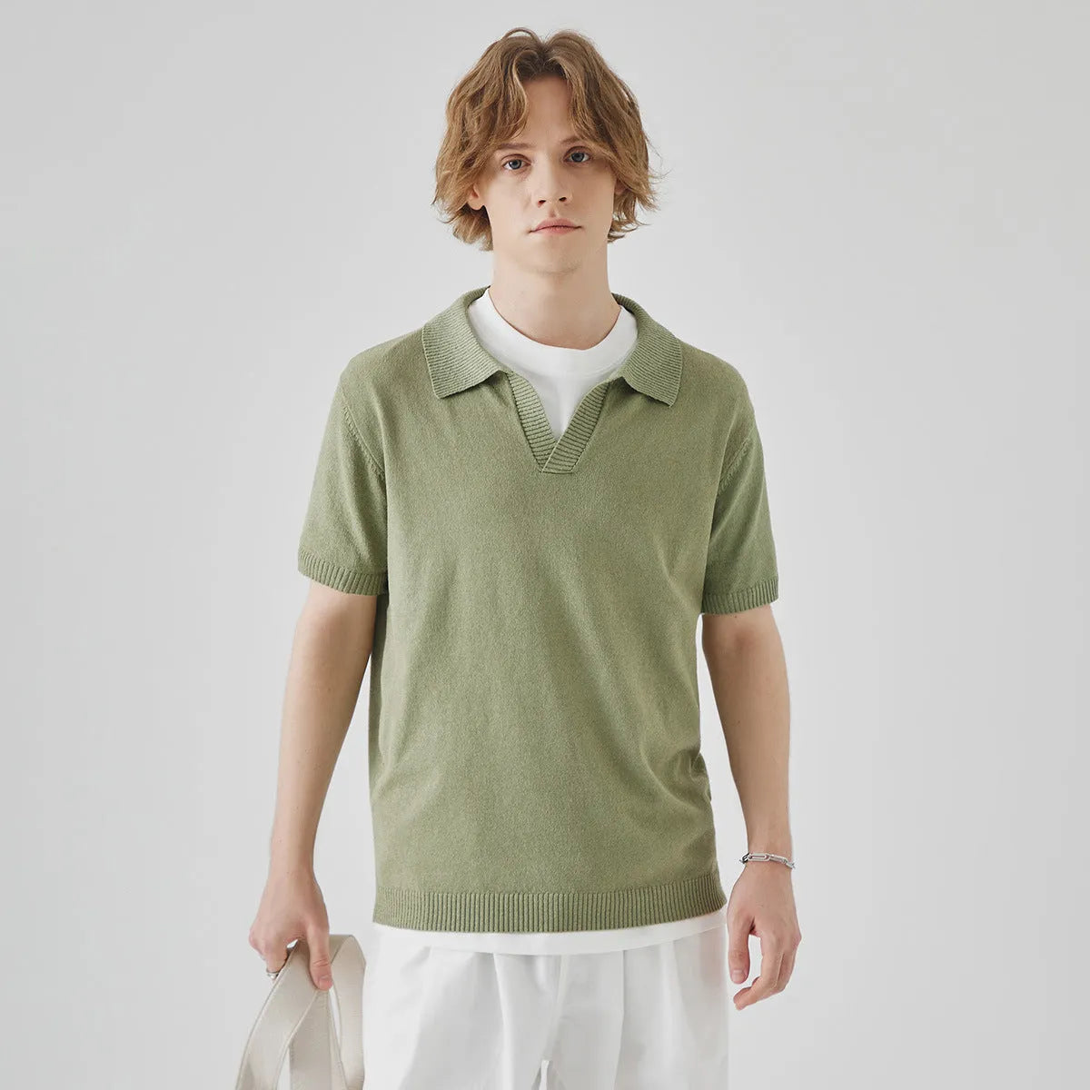 Men's solid colour knitted polo T-shirt in acrylic fabric for summer, shown on a hanger.