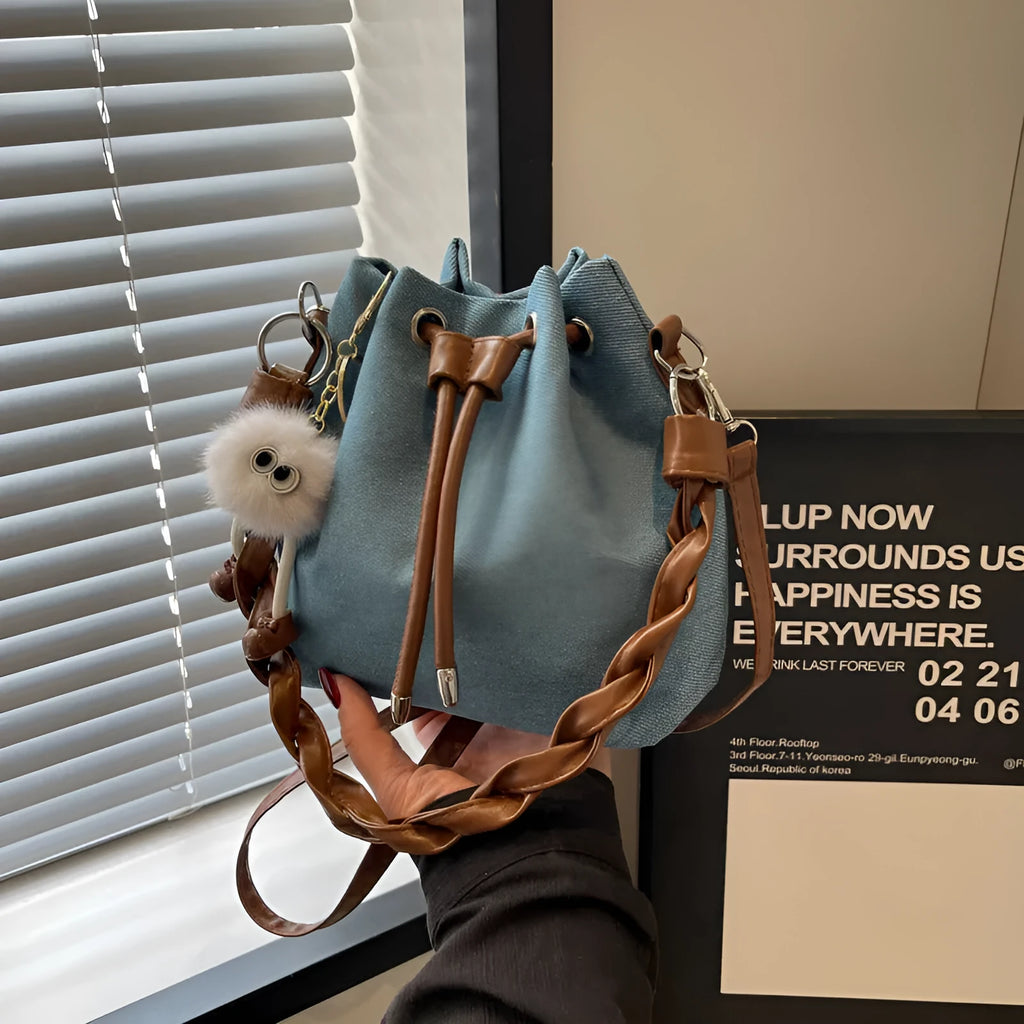 Blue one-shoulder cross body bucket messenger bag with a strap.