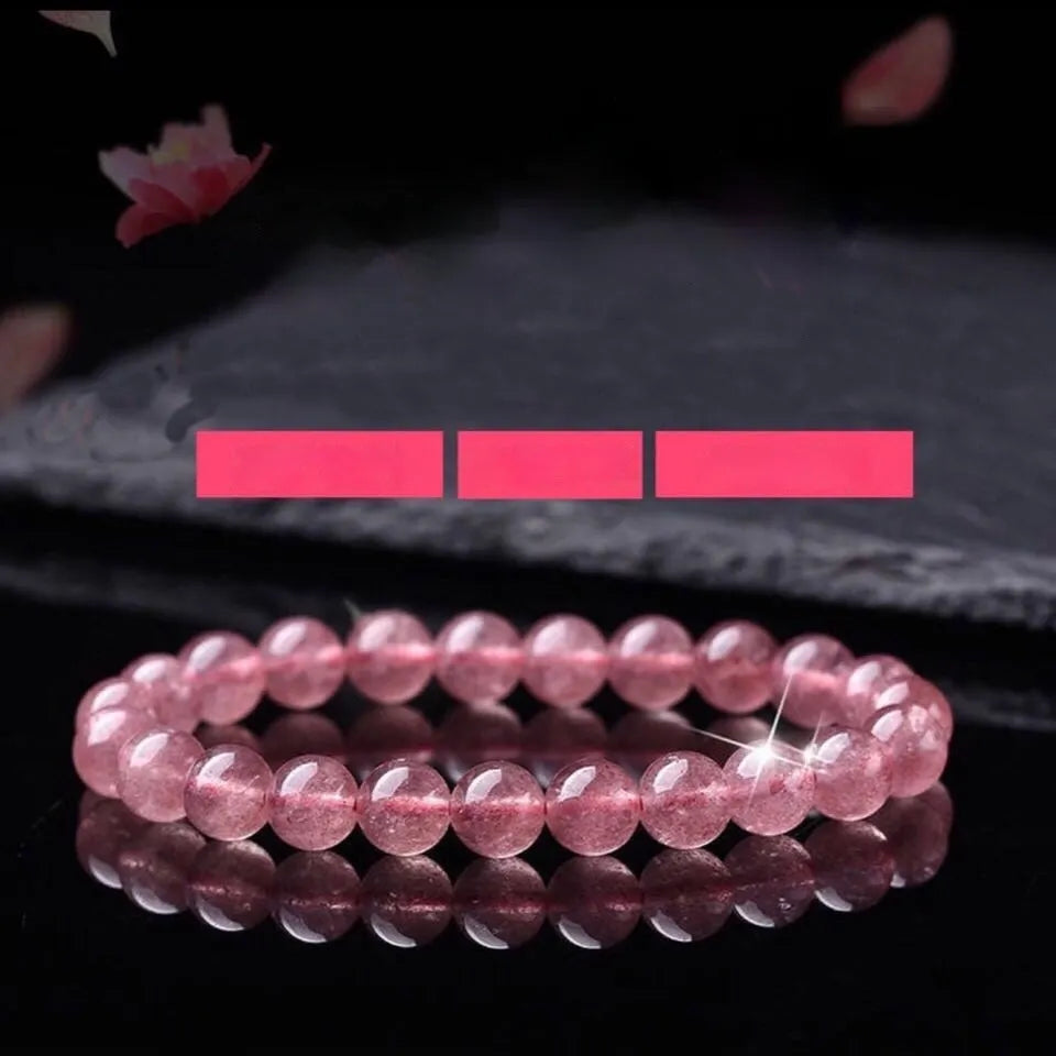 Women's strawberry quartz bracelet with polished crystal beads in 6mm, 8mm, or 10mm sizes on a wrist
