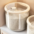 Transparent plastic grain storage tank with measuring cup, showing clear capacity markings.