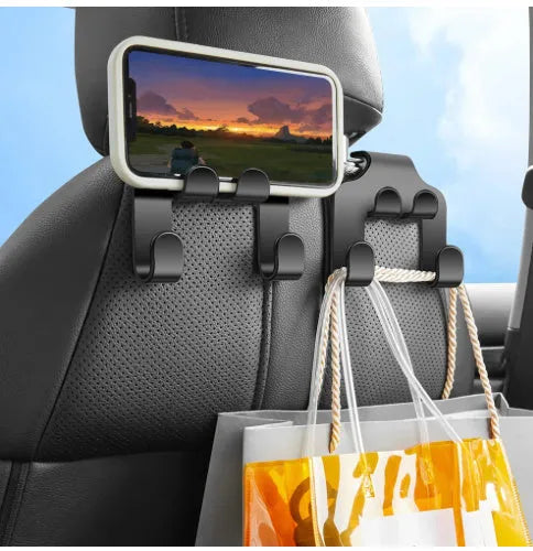 Two white ABS plastic car multifunction holder hooks mounted on a car dashboard.