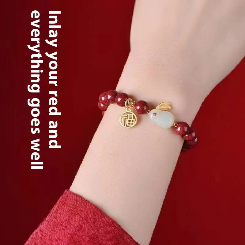Cinnabar hare bracelet with purple gold sand beads on a wrist, showing retro jewellery style.
