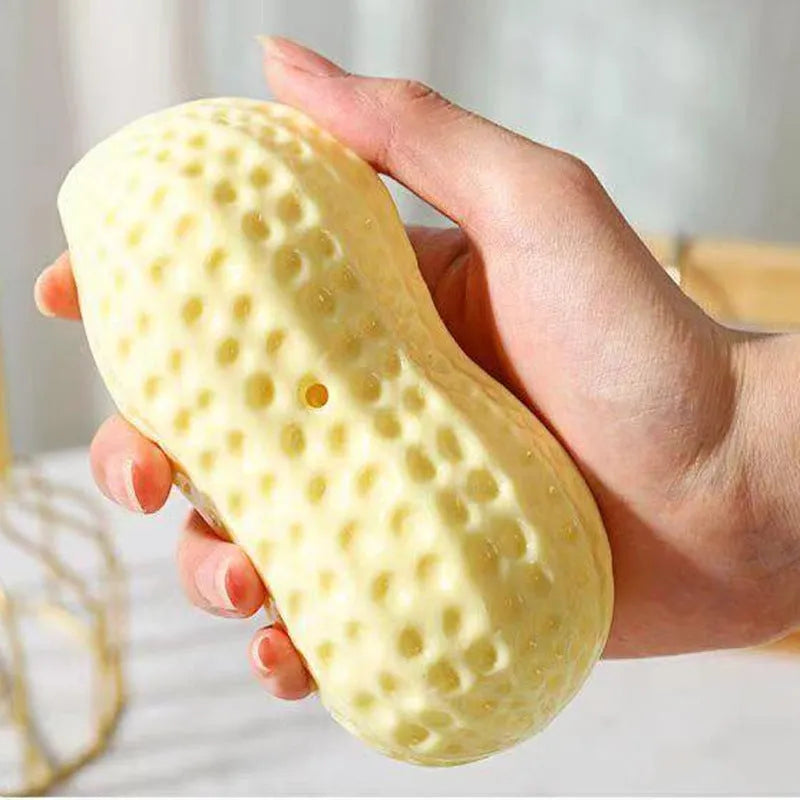 Yellow TPR peanut-shaped dog chew toy with textured surface and squeaker function