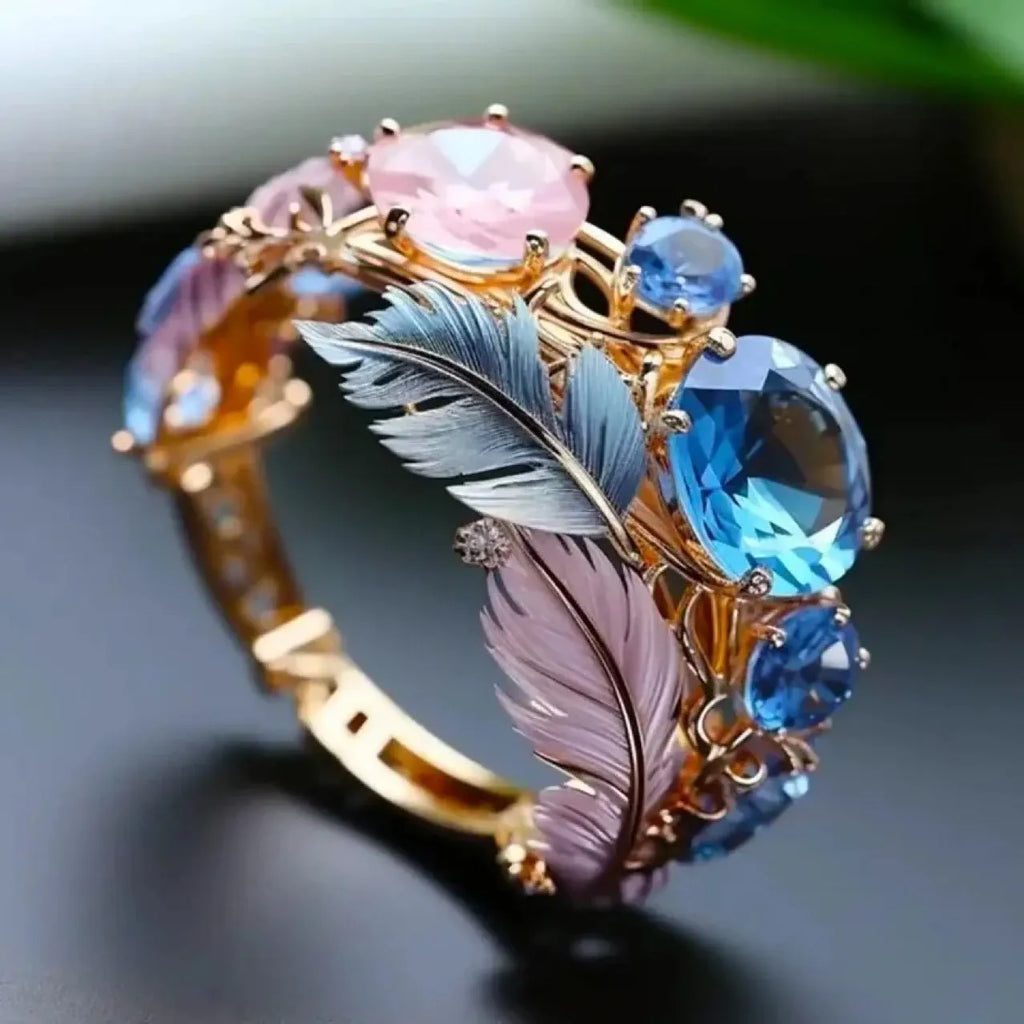 Gold colour brass feather ring with geometric embossed design and colourful zircon stone inlay