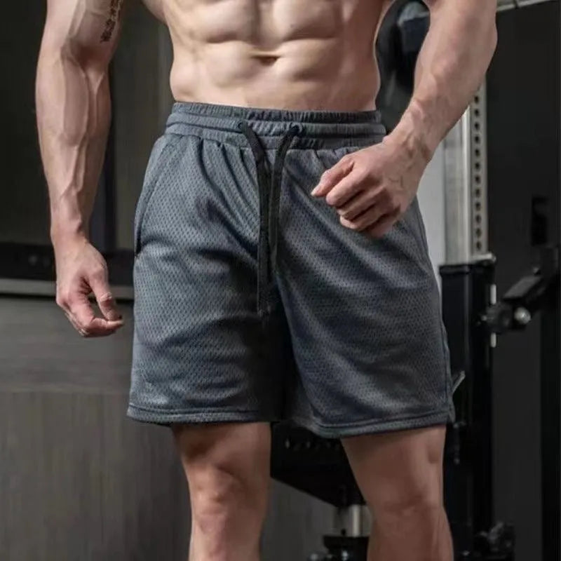 Men's light grey sports shorts with breathable mesh panels and straight leg loose fit design