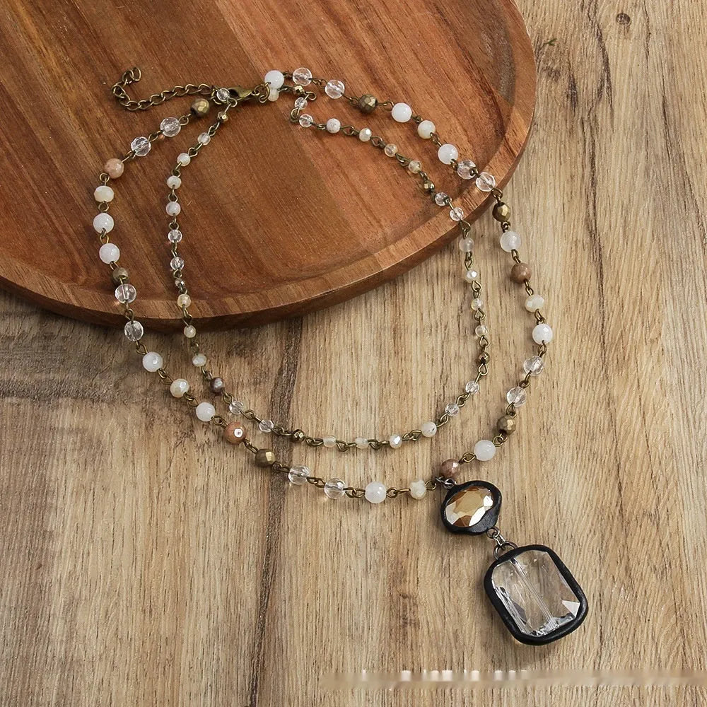Two-layer tribal necklace with a stone and glass pendant on an alloy chain.