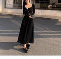 Women's black square collar knitted dress with elastic waist and long A-line skirt, made from polyester fabric.