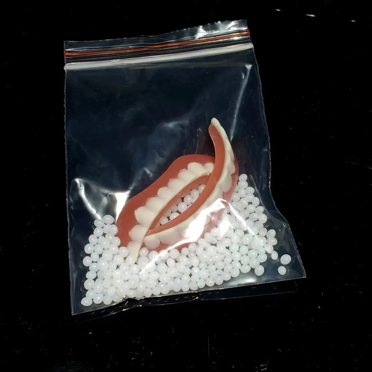 Silicone simulation dentures showing upper and lower teeth in natural colour for dental training