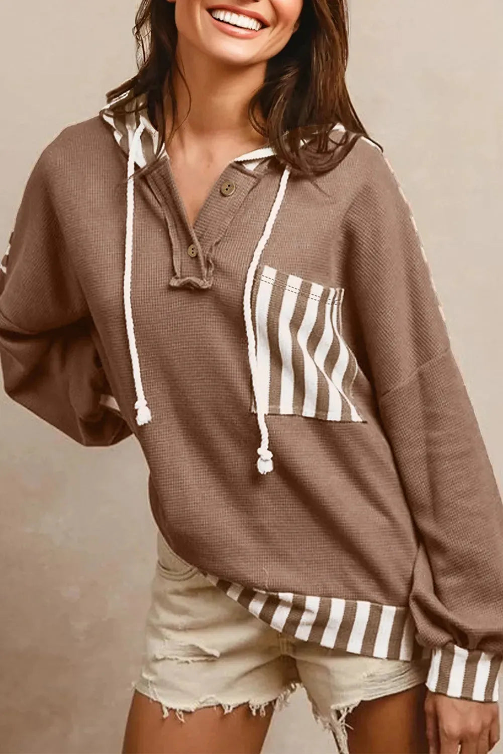 Straw yellow hoodie with waffle texture, striped patchwork design, button neck, and drawstring hood in sizes S M L XL