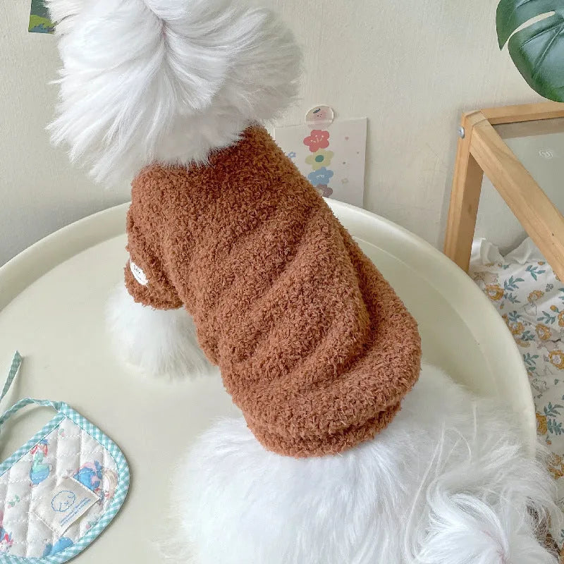 Brown double-sided cloud velvet dog coat with fluffy texture and elastic openings on a small dog.