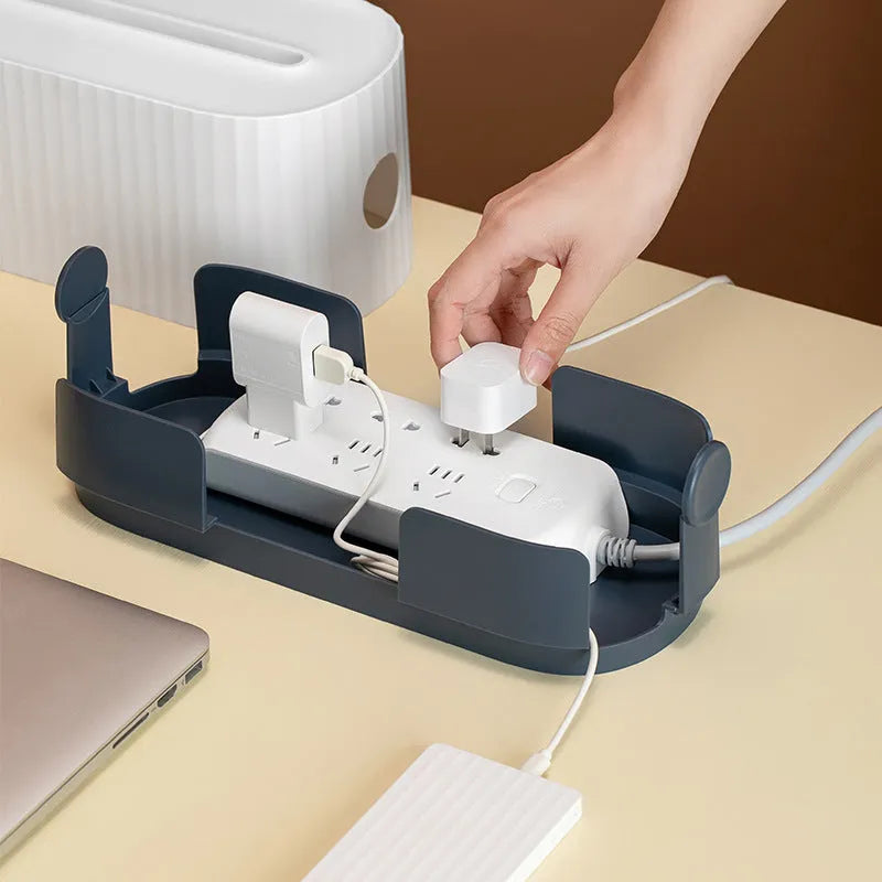 Blue and white power strip storage box with lid showing cable holes and internal phone slot