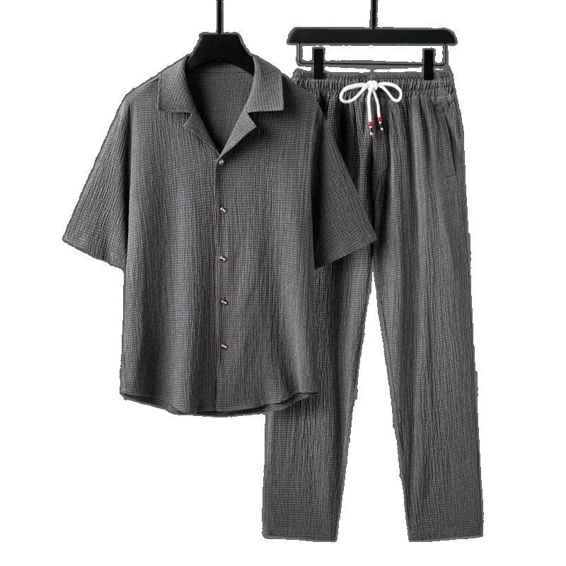 Men's Chinese style two-piece sports set with short sleeve shirt and trousers in polyester fabric