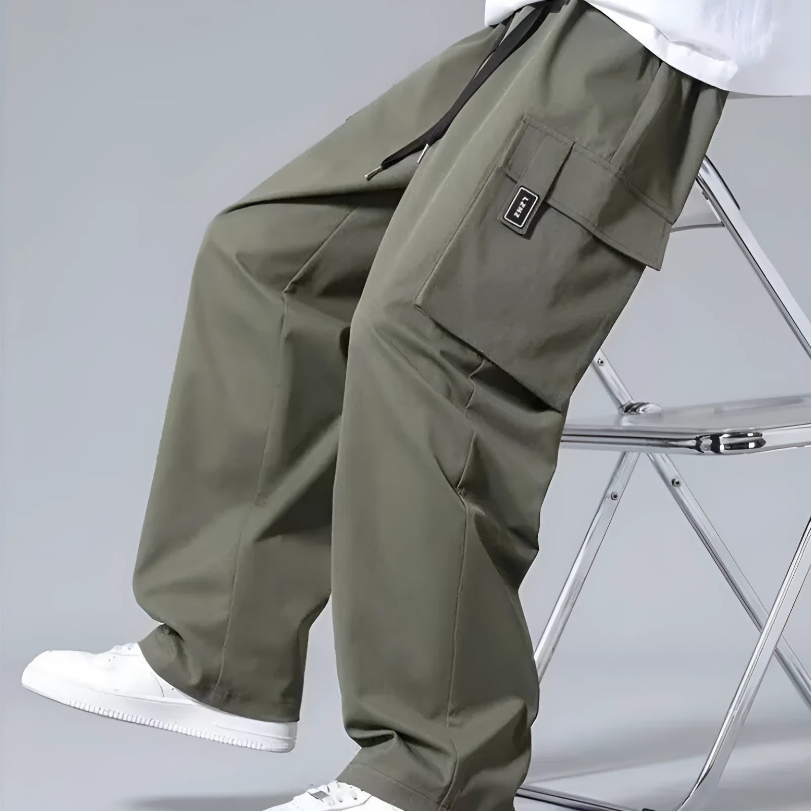 Boys' straight leg cargo trousers in army green with large cargo pockets and a drawstring waistband.