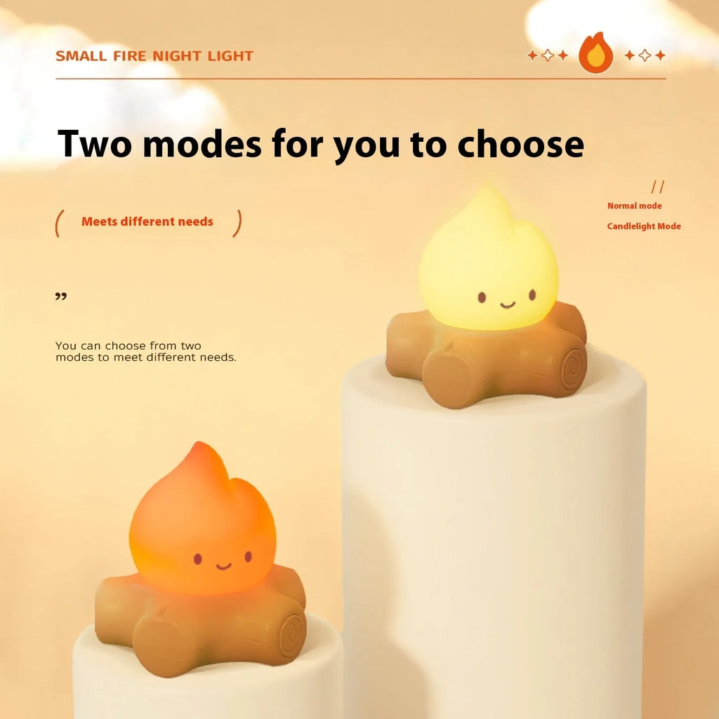 Silicone small fire pile cartoon night lamp with yellow light on wooden surface