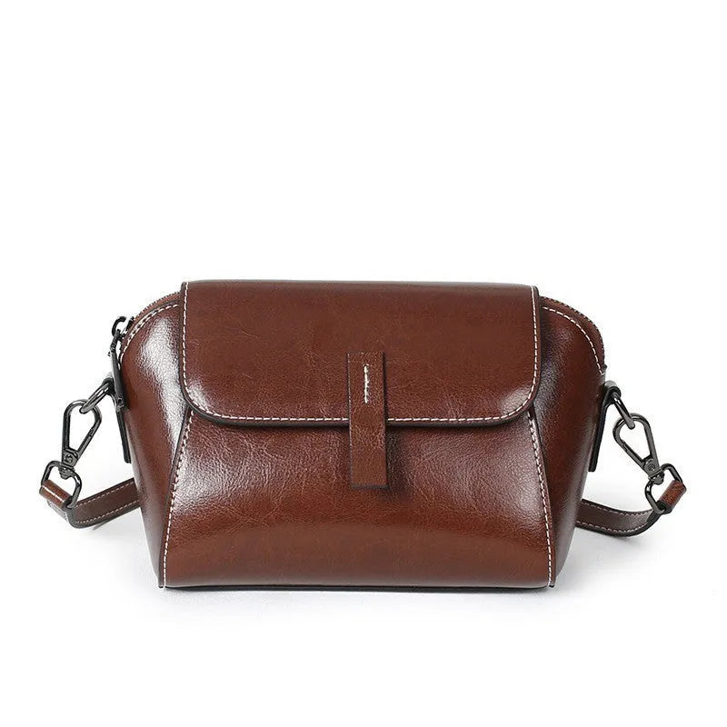 Women's brown oil wax cowhide shell messenger bag with cross-body strap and exterior sandwich pocket