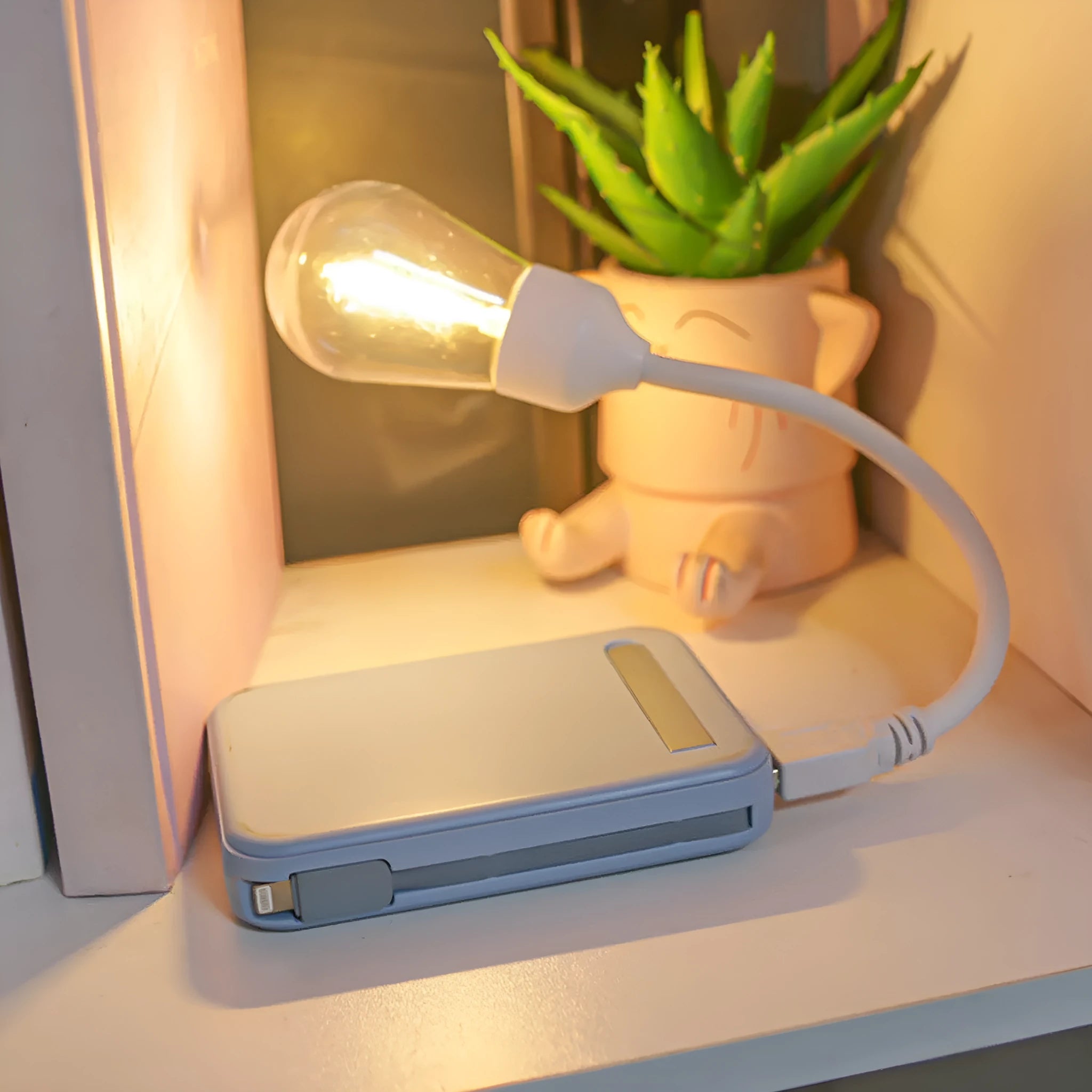 USB rechargeable folding tungsten night light with glowing S14 bulb on a table.