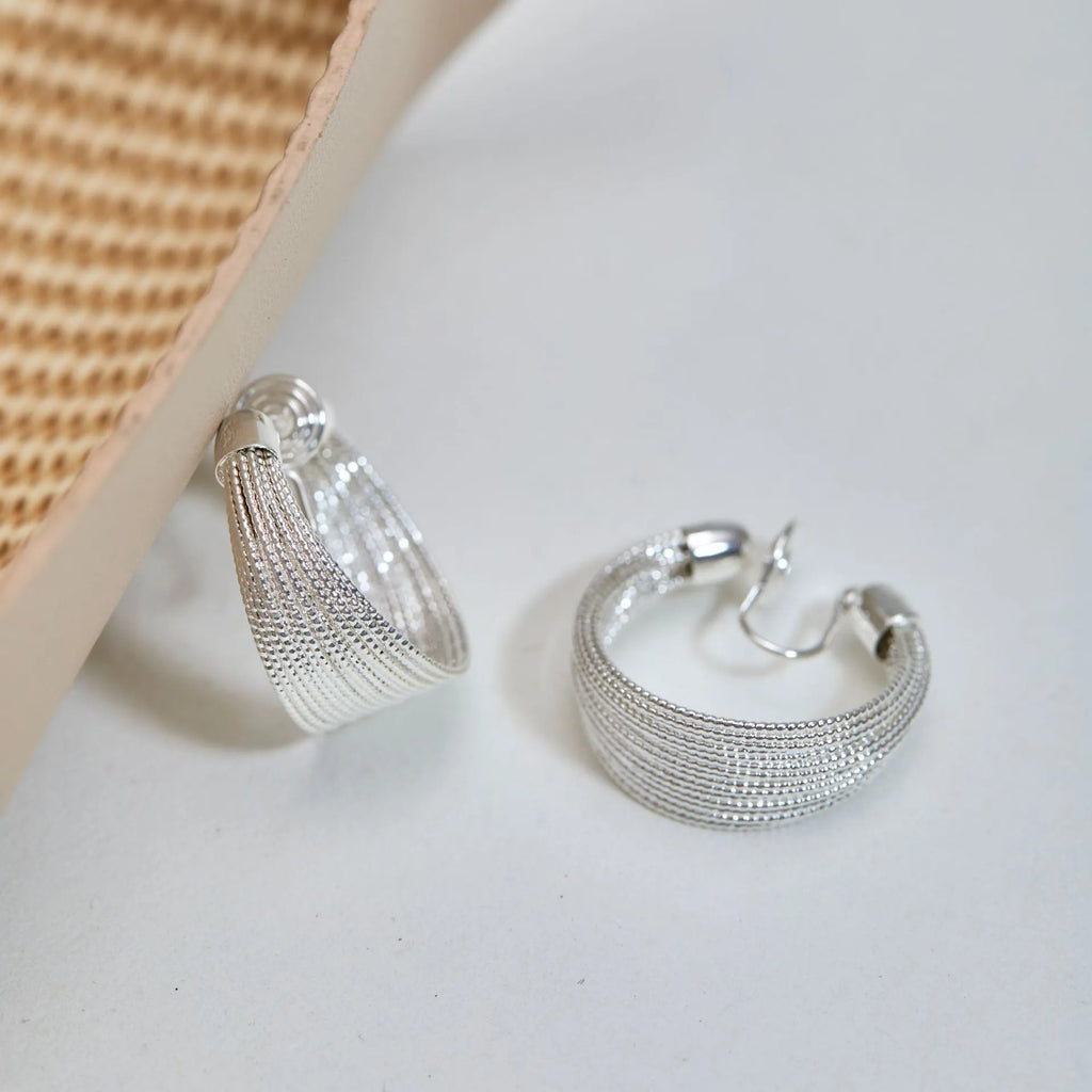 Geometric multi-layer copper earrings with electroplated silver or gold finish, showing stud and clip-on design options
