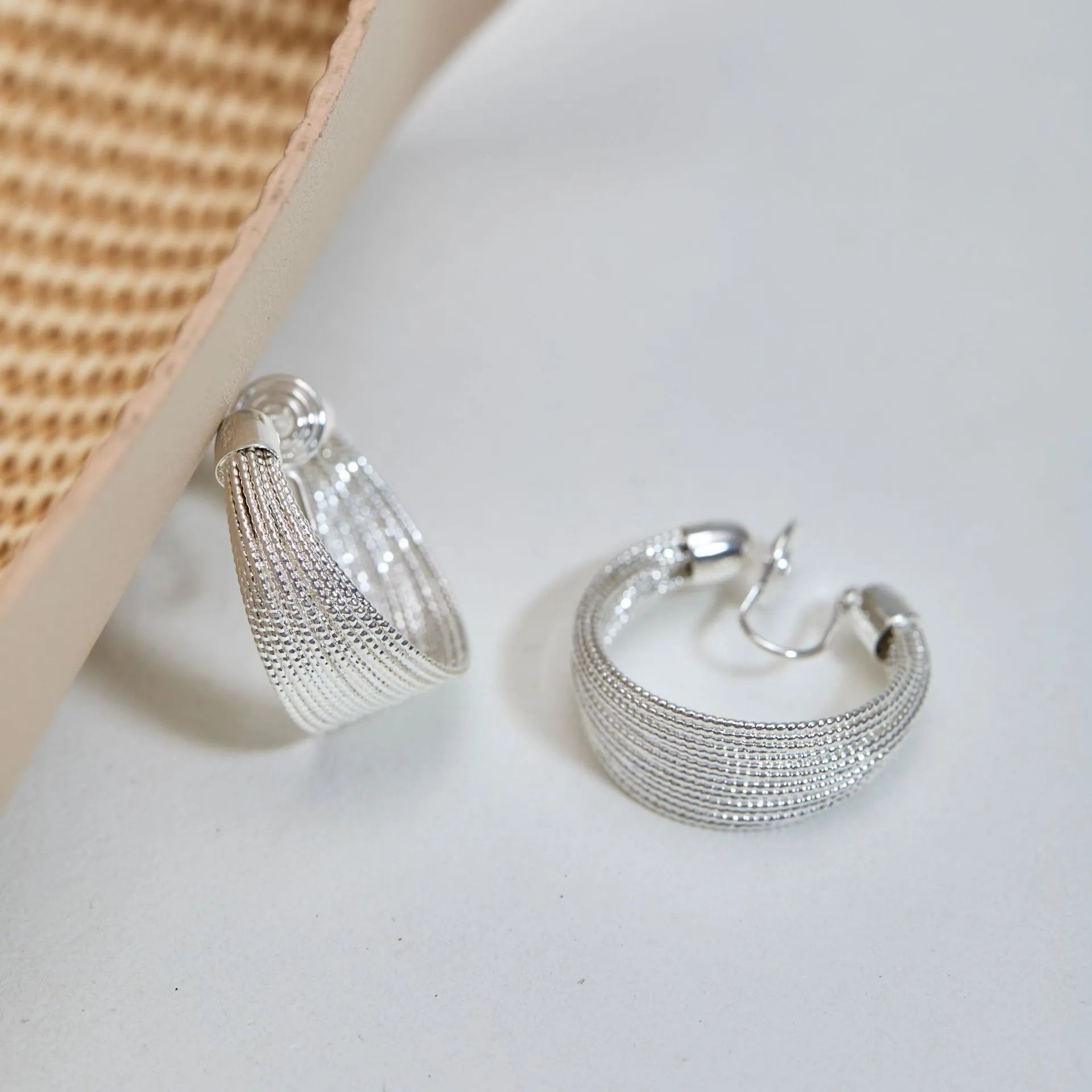 Geometric multi-layer copper earrings with electroplated silver or gold finish, showing stud and clip-on design options
