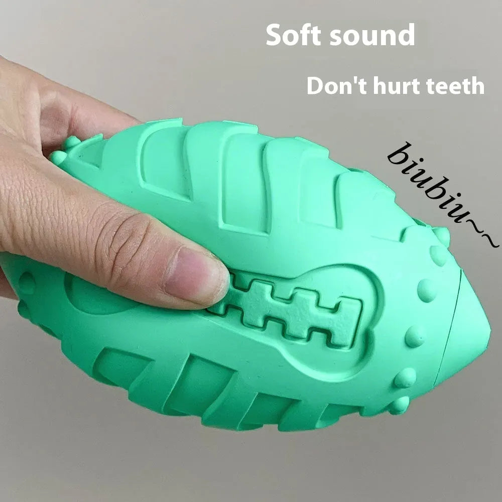Light green rubber rugby ball dog toy with bite-resistant texture for interactive play and teeth cleaning.
