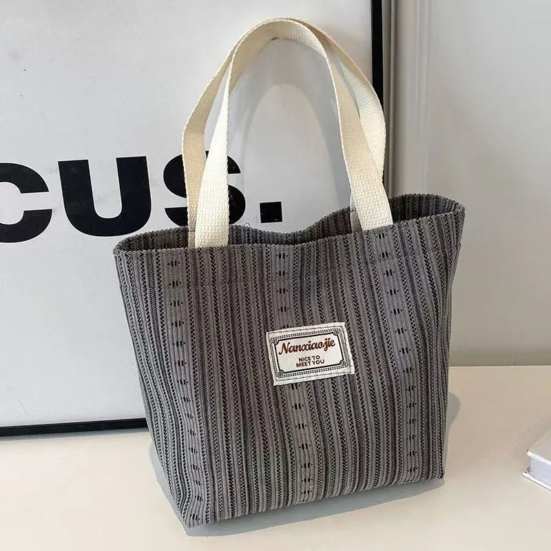 Japanese style large capacity corduroy handbag in dark brown, shown front view.