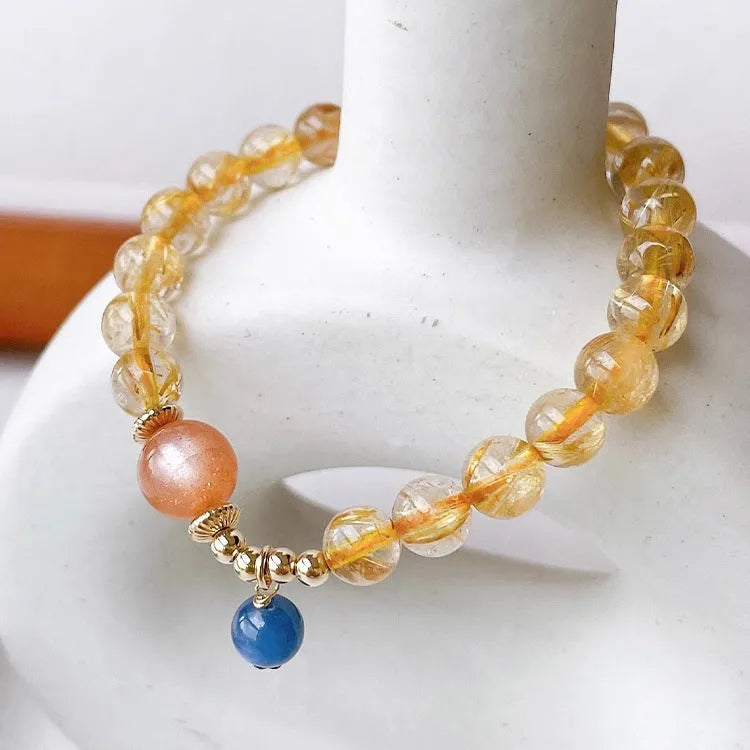 Women's gold rutilated quartz and sunstone crystal bracelet with round beads on elasticated band