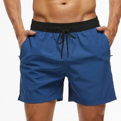 Men's blue athletic shorts with multiple pockets, drawstring waistband, and stitching detail for running and fitness activities