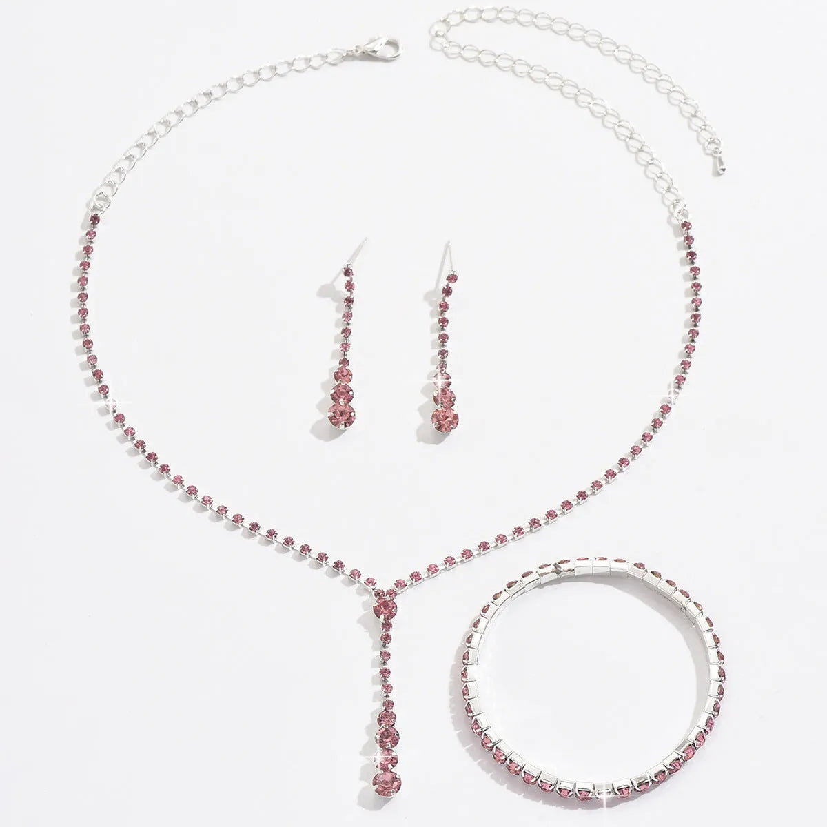 Women's rhinestone wedding jewellery set with heart pendants and tassel details in silver, rose gold, black, or pink