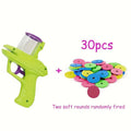 Green interactive cat toy launcher with foam discs on wooden floor