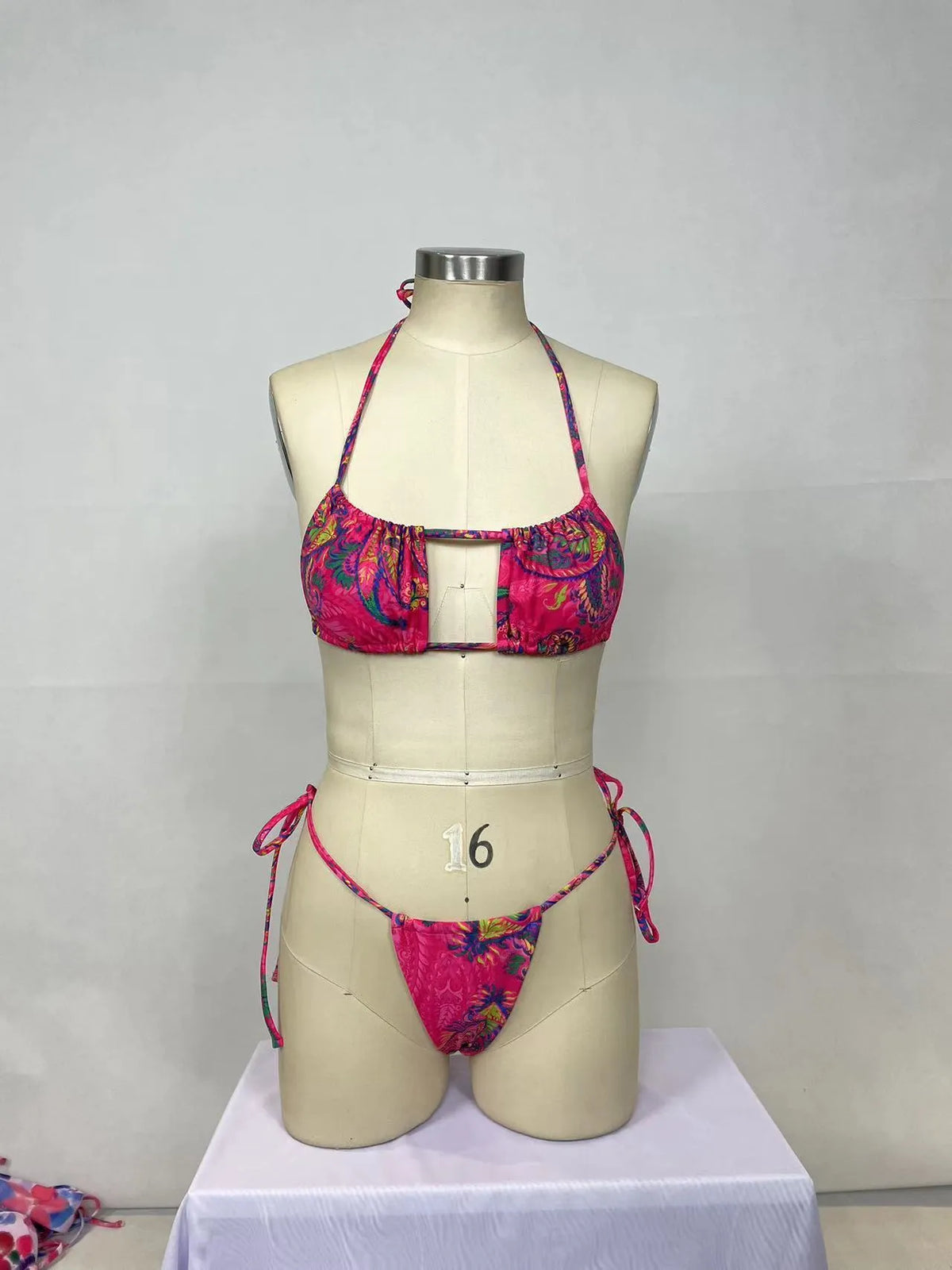 Pink printed women's bikini two-piece set with brief triangle style, shown from front.