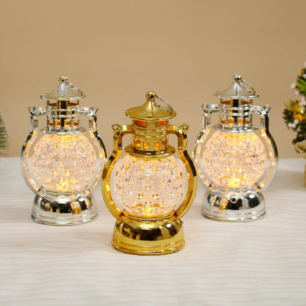 Creative retro-style small oil lamp LED night light in gold or silver finish on a table.