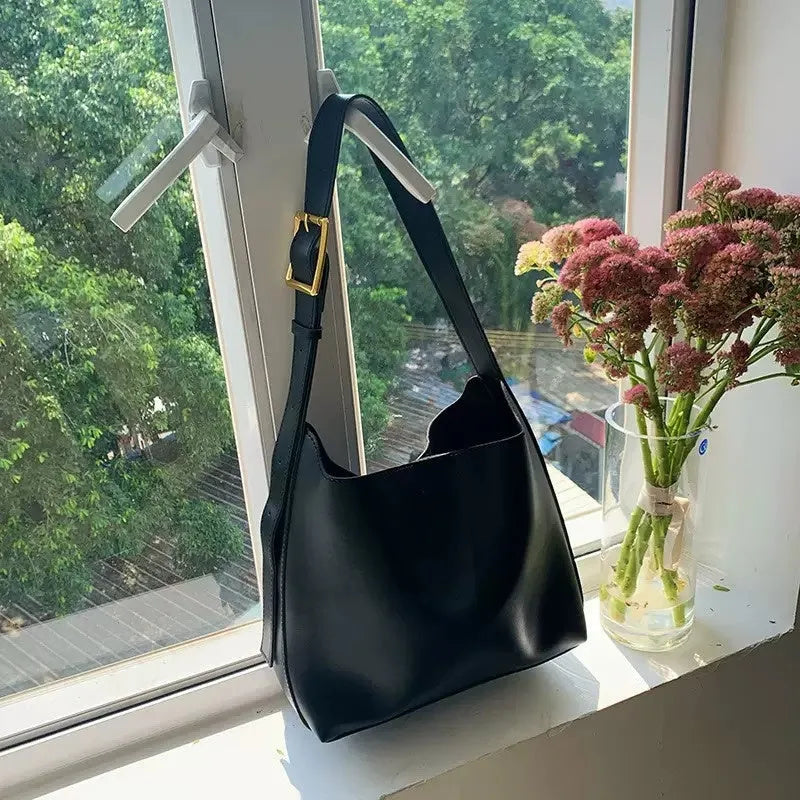 Two soft PU women's shoulder bags with swing threads decoration, shown in black and brown colour options.