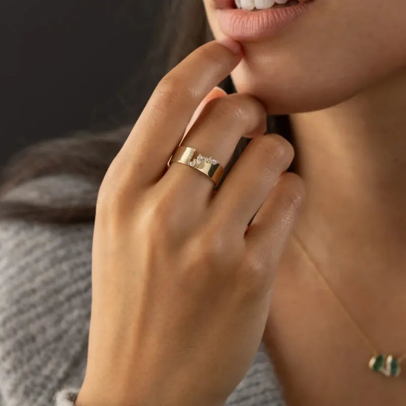 Women's gold electroplated copper ring with zircon stone, showing side and top views